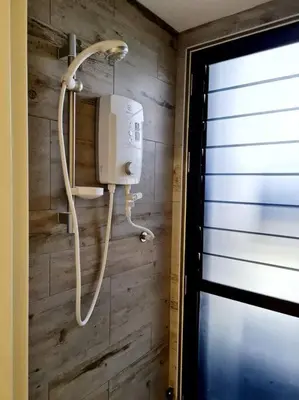 a bathroom with a phone on a wooden wall at Best Affordable Homestay, Arte Mont Kiara, KL in Kuala Lumpur