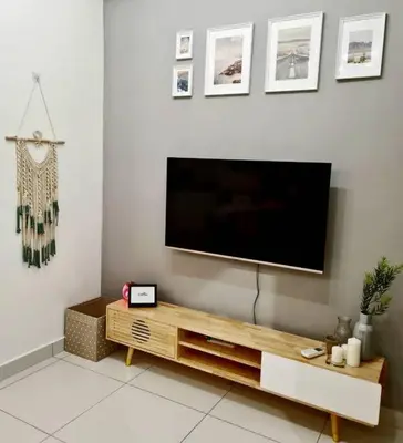 a living room with a flat screen tv on a wall at Best Affordable Homestay, Arte Mont Kiara, KL in Kuala Lumpur