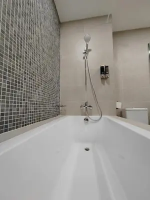 a bathroom with a bath tub with a shower at The Ooak Mont Kiara 33A# Main Street Sunway 163#1 bedroom 1-2Pax in Kuala Lumpur