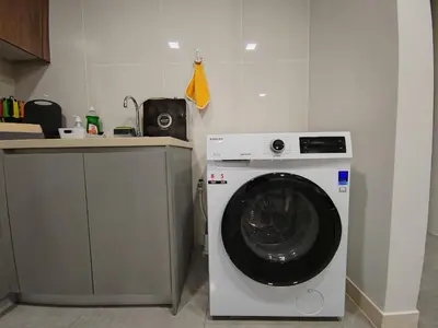a washing machine in a kitchen next to a counter at The Ooak Mont Kiara 33A# Main Street Sunway 163#1 bedroom 1-2Pax in Kuala Lumpur