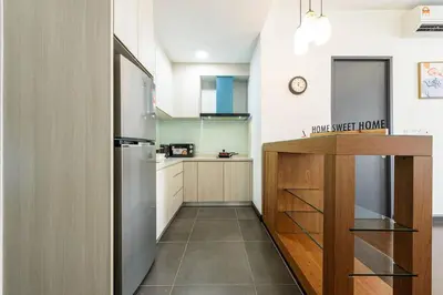 a kitchen with a counter and a refrigerator at Cozy KL Sunway Velocity Residence for 1-5pax connected to MRT & Malls in Kuala Lumpur