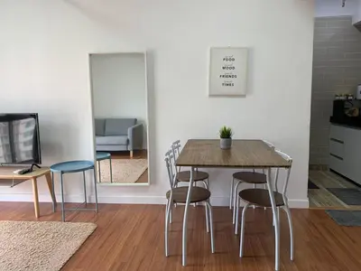 a dining room with a table and chairs and a tv at Menara Arina Uniti in Kuala Lumpur