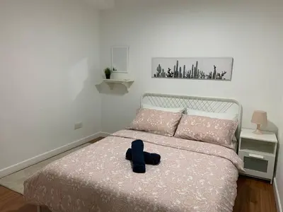 a stuffed animal sits on a bed in a bedroom at Menara Arina Uniti in Kuala Lumpur