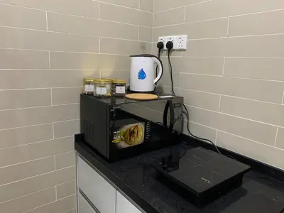 a kitchen with a microwave and a coffee maker on a counter at Menara Arina Uniti in Kuala Lumpur