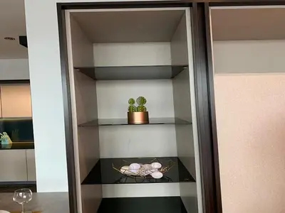 a shelf with a potted plant and a cactus at Luxury Apartment at Scarletz Suites Kuala Lumpur in Kuala Lumpur