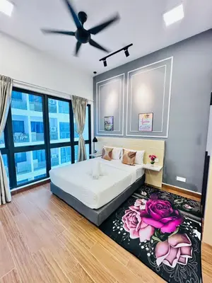 a bedroom with a bed with pink roses on a rug at The Luxe Infinitum Sky pol KLCC in Kuala Lumpur