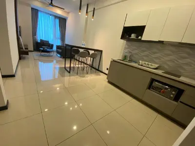 a kitchen and living room with a table and chairs at Kuala Lumpur Apartment at Opus Residence Near China Town and 118 Tower in Kuala Lumpur