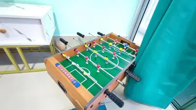 a table with a hockey game in a room at 3A YOLO Budget Condo in Kuala Lumpur