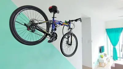 a bike hanging from a wall in a room at 3A YOLO Budget Condo in Kuala Lumpur