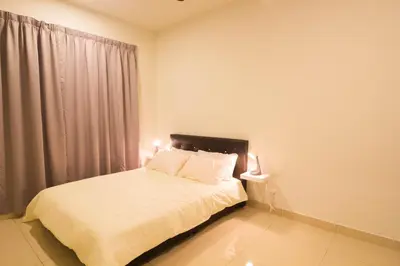 a bedroom with a bed with white sheets and a window at KL 9Pax 10Mins to Sentul LRT, Batu Caves, MCD (Zena Suites) in Kuala Lumpur