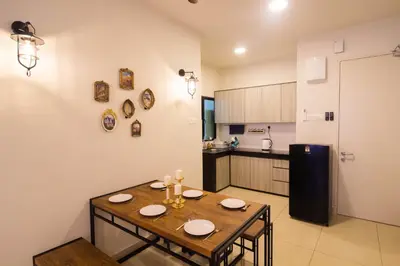 a kitchen with a wooden table in a room at KL 9Pax 10Mins to Sentul LRT, Batu Caves, MCD (Zena Suites) in Kuala Lumpur