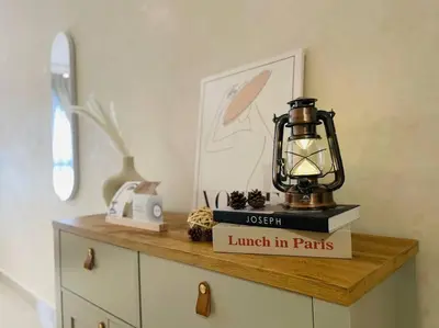 a lantern sitting on top of a shelf with books at M Vertica Residences@KL in Kuala Lumpur