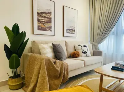 a living room with a white couch with pillows at M Vertica Residences@KL in Kuala Lumpur