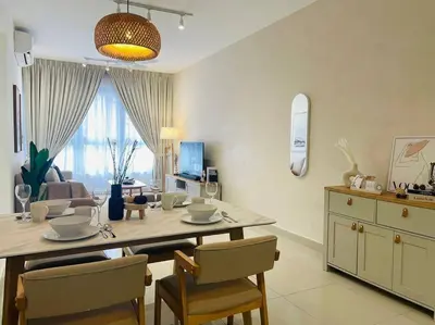 a living room with a dining room table with chairs at M Vertica Residences@KL in Kuala Lumpur