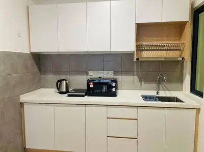 a kitchen with white cabinets and a toaster on a counter at M Vertica Residences@KL in Kuala Lumpur