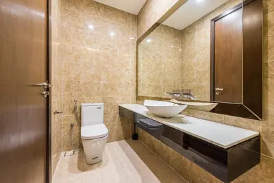 a bathroom with a toilet and a sink and a mirror at Dorsett Residence Kuala Lumpur \u5e1d\u76db\u516c\u5bd3 Bukit Bintang in Kuala Lumpur
