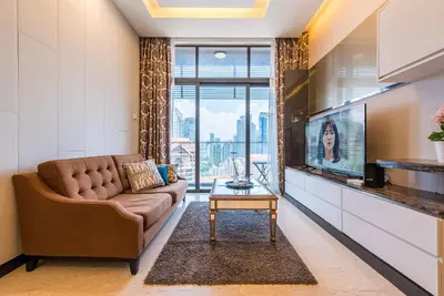 a living room with a couch and a tv at Dorsett Residence Kuala Lumpur \u5e1d\u76db\u516c\u5bd3 Bukit Bintang in Kuala Lumpur