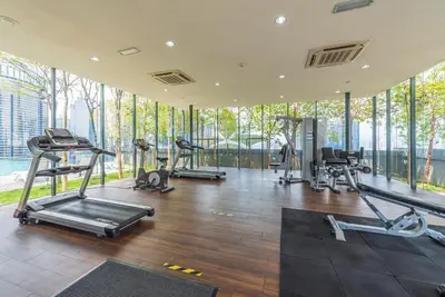 a gym with several treadmills and elliptical machines at Dorsett Residence Kuala Lumpur \u5e1d\u76db\u516c\u5bd3 Bukit Bintang in Kuala Lumpur
