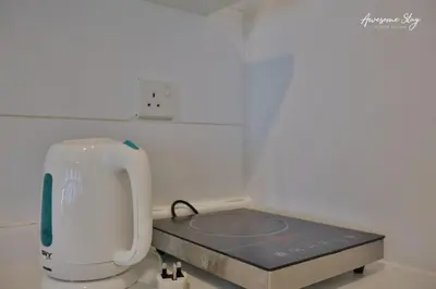 a machine in a white room with a table at Arte plus by 2BR sweet home in Kuala Lumpur