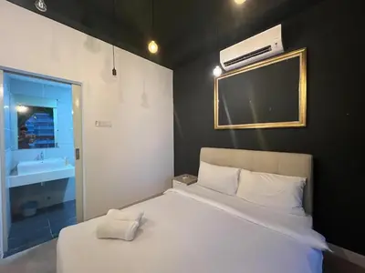 a bedroom with a white bed with a tv on the wall at Arte plus by 2BR sweet home in Kuala Lumpur