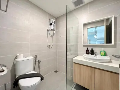 a bathroom with a shower and a toilet and a sink at Court 28 Residence KL Suites 2 Bedroom Apartment by Sleepy Bear in Kuala Lumpur
