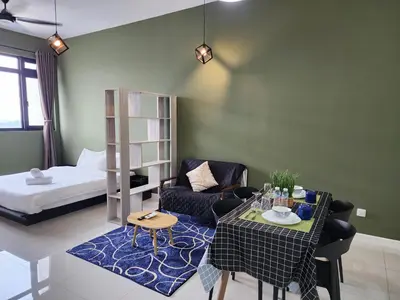 a living room with a table and a bed at Chambers Residences Suites KLCC in Kuala Lumpur