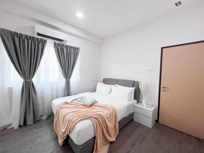 a white bedroom with a bed and a large window at Maison Signature Suites in Kuala Lumpur