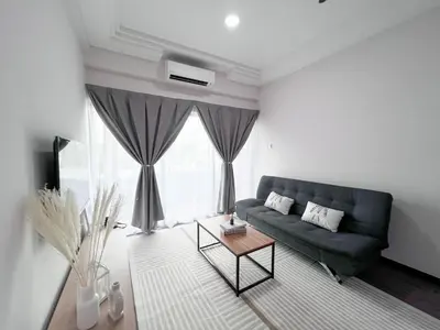 a living room with a couch and a table at Maison Signature Suites in Kuala Lumpur