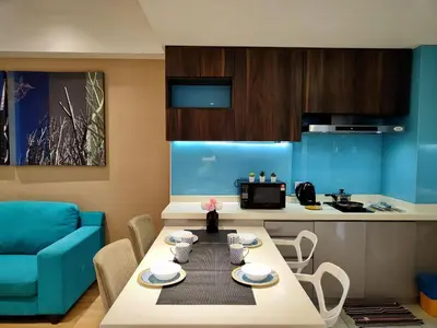 a living room with a table and a kitchen at D'Majestic Place Jalan Pudu in Kuala Lumpur