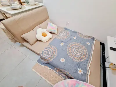 a couch with a blanket and a stuffed animal on it at KL Creamy Tiny 2R1B Home \u7206\u6b3e\u5976\u6cb9\u98ce\u5c0f\u5b85 in Kuala Lumpur