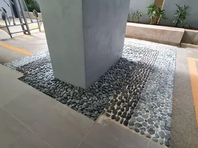 a stone walkway with a pillar in a building at KL Creamy Tiny 2R1B Home \u7206\u6b3e\u5976\u6cb9\u98ce\u5c0f\u5b85 in Kuala Lumpur