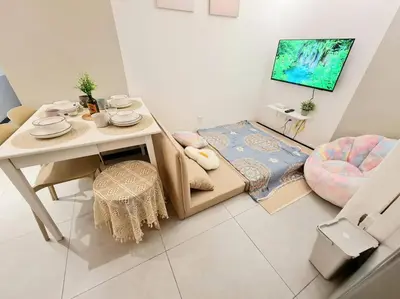 a living room with a table and a chair at KL Creamy Tiny 2R1B Home \u7206\u6b3e\u5976\u6cb9\u98ce\u5c0f\u5b85 in Kuala Lumpur