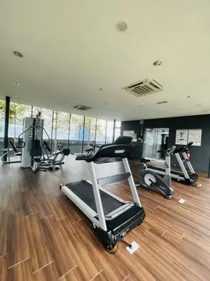 a gym with several treadmills and exercise machines at The Dorsett Service Suites Bukit Bintang Kuala Lumpur in Kuala Lumpur