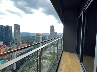 a balcony in a building with a view of a city at The Dorsett Service Suites Bukit Bintang Kuala Lumpur in Kuala Lumpur