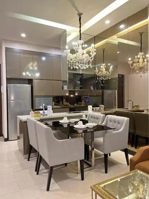 a kitchen and dining room with a table and chairs at The Dorsett Service Suites Bukit Bintang Kuala Lumpur in Kuala Lumpur
