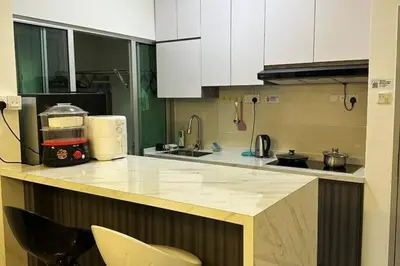 a kitchen with white cabinets and a counter top at Corner KL Pool View RC Residence with High Internet Speed 500Mbps in Kuala Lumpur