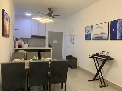 a kitchen and dining room with a table and chairs at Corner KL Pool View RC Residence with High Internet Speed 500Mbps in Kuala Lumpur