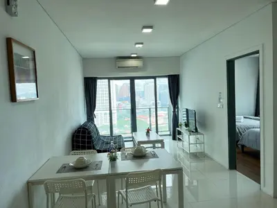 a living room with a table and chairs and a bedroom at Summer suites victory house in Kuala Lumpur