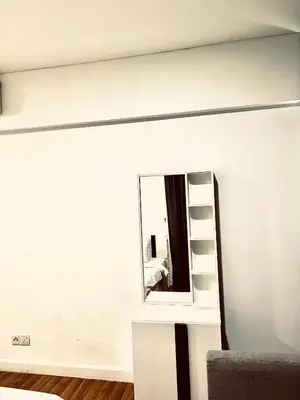 a mirror on a wall next to a room at Summer suites victory house in Kuala Lumpur