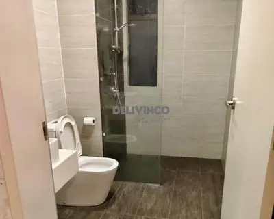 a bathroom with a toilet and a glass shower at Trion - KL - 2BR - 6pax - 15min to KLCC & TRX in Kuala Lumpur