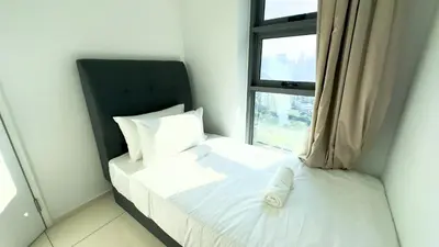 a small bedroom with a bed with a window at Extravagant Family-Biz Nest @ Robertson 30F in Kuala Lumpur