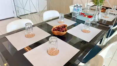 a glass table with four glasses and a bowl of fruit at Extravagant Family-Biz Nest @ Robertson 30F in Kuala Lumpur
