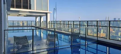 a balcony with three chairs and a view of a city at Mercure Kuala Lumpur Trion in Kuala Lumpur