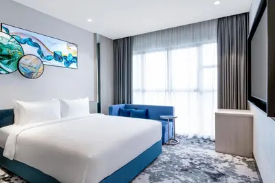 a hotel room with a bed and a tv at Mercure Kuala Lumpur Trion in Kuala Lumpur