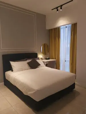 a bedroom with a large white bed and a window at Bukit Bintang Axon Residences 3R2B 3Queens Beds in Kuala Lumpur