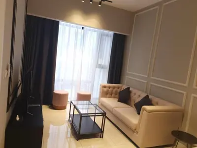 a living room with a couch and a glass table at Bukit Bintang Axon Residences 3R2B 3Queens Beds in Kuala Lumpur