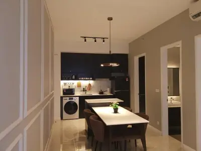 a kitchen with a table and chairs and a kitchen with a stove at Bukit Bintang Axon Residences 3R2B 3Queens Beds in Kuala Lumpur