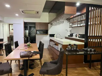 a kitchen and dining room with a table and chairs at One Enigma Hotel in Kuala Lumpur