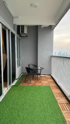 a patio with a table and chairs on a balcony at Razak City Residence by Lisa Homestay in Kuala Lumpur