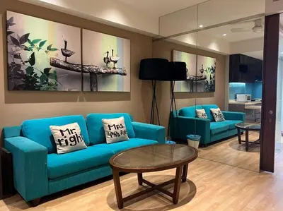 a living room with a blue couch and a table at D'Majestic Kuala Lumpur By Luxe Home in Kuala Lumpur